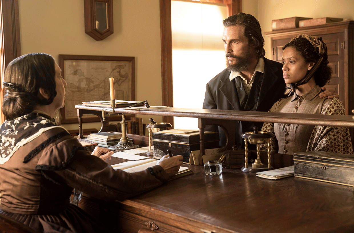 Newt (Matthew McConaughey) and Rachel (Gugu Mbatha-Raw) talk to a woman (Maggie Eldred) in the county clerk's office about deeding some land. © 2015 STX Productions.