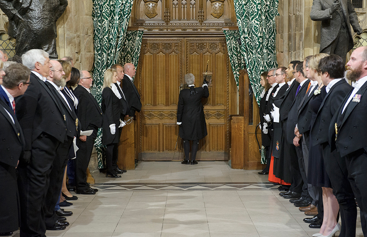 Black Rod knocks three times at the door of the Chamber of Commons.