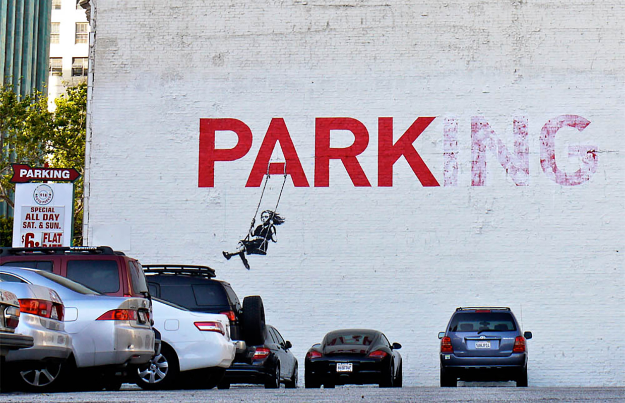Banksy loves to integrate elements he finds on walls into his work, like this joyful play on words.