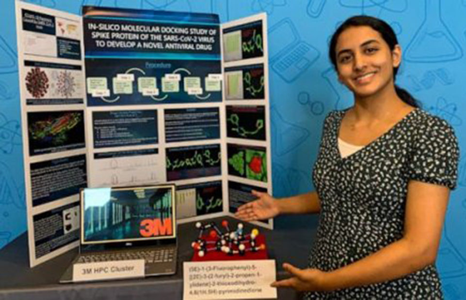 Anika shows a display explaining her experiment.