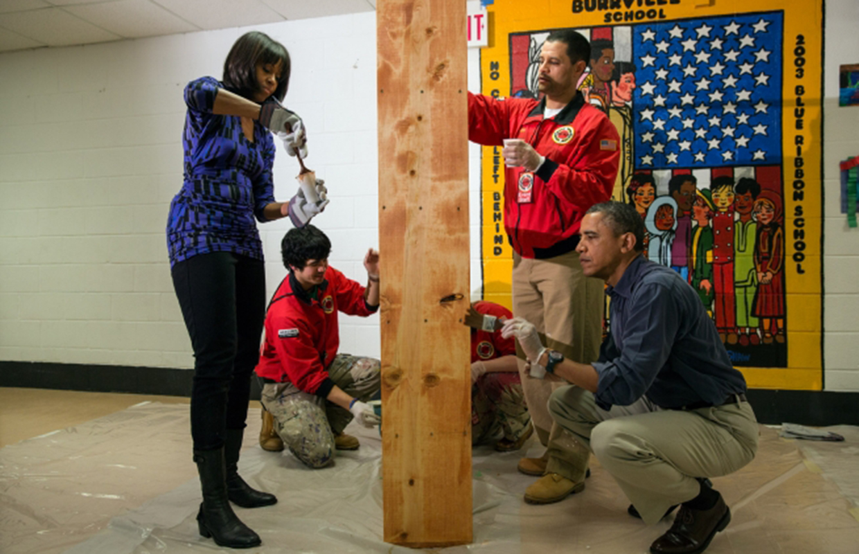 Michelle and Barack Obama help varnish shelves in a Washington, D.C. school.
