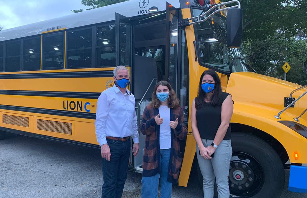 Holly, centre, after a trip on a new electric school bus.