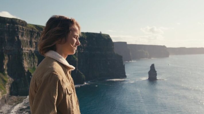 Ben standing on a cliff looking out to sea.