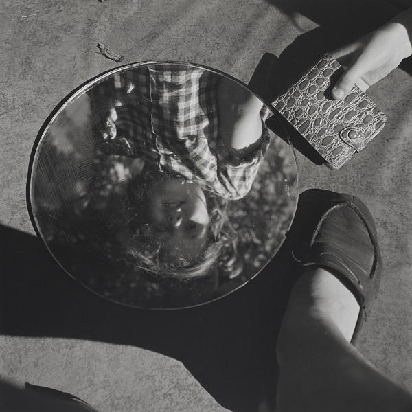 a photo of child reflected in a mirror and Maier's foot