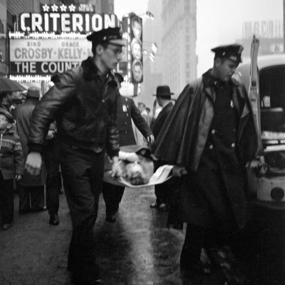 Police carrying a person on a stretcher in front of the Criterion Cinema in New York.