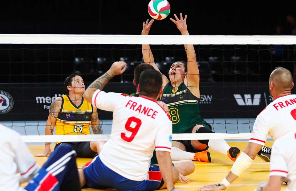 The French and Australian teams playing sitting volleyball.