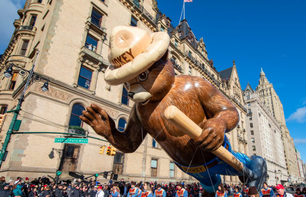 Smokey Bear balloon dressed as a ranger and carrying an axe.