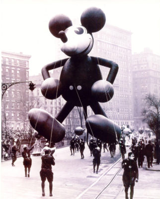 A black and white photo of a giant Mickey Mouse helium balloon.