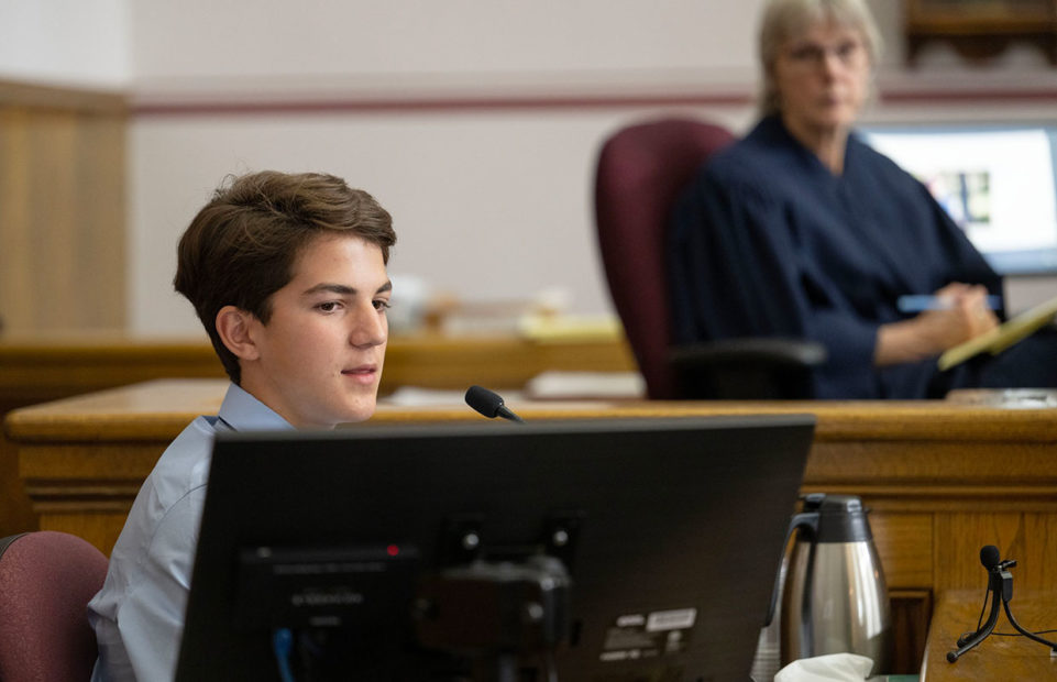 Youth plaintiff Mica K., 14, giving evidence in court. Smoke from frequent wildfires limits his ability to train for and compete in long-distance running.