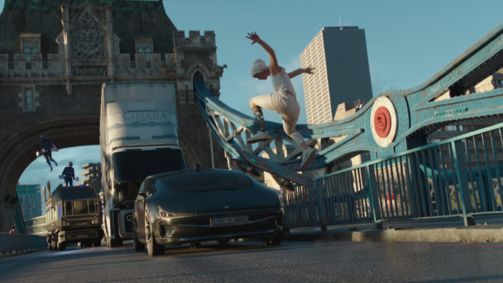 A still from the film where a young woman on a hoverboard flies over a car on London Bridge.