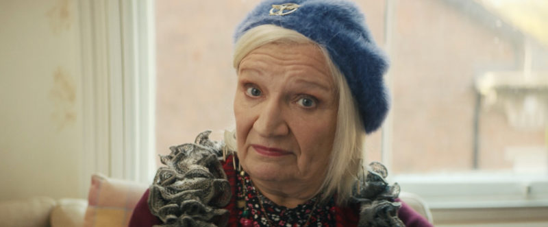 A middle-aged woman in a blue beret looking sceptical.