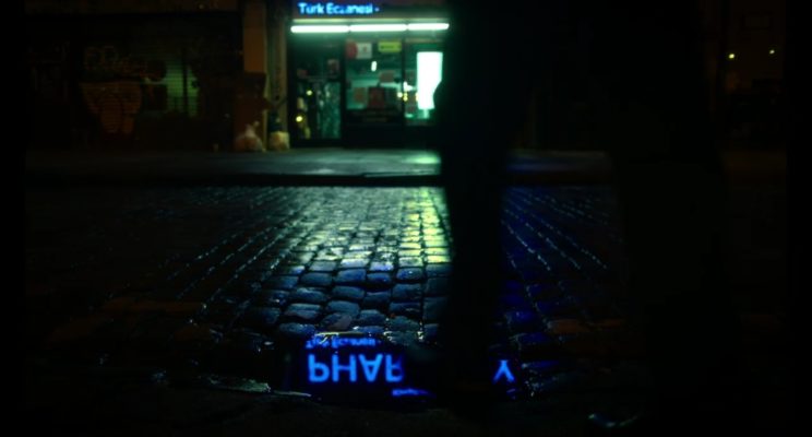 A view of a pharmacy on a cold, wet night.