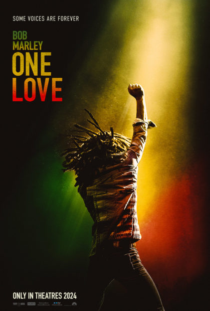 The poster for One Love, showing Bob Marley on stage from behind, fist raised, and using Rasta colours green yellow and red.