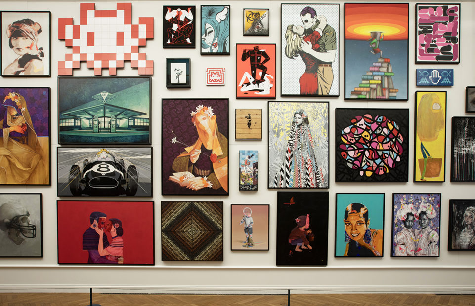 A wall full of colourful urban art paintings.
