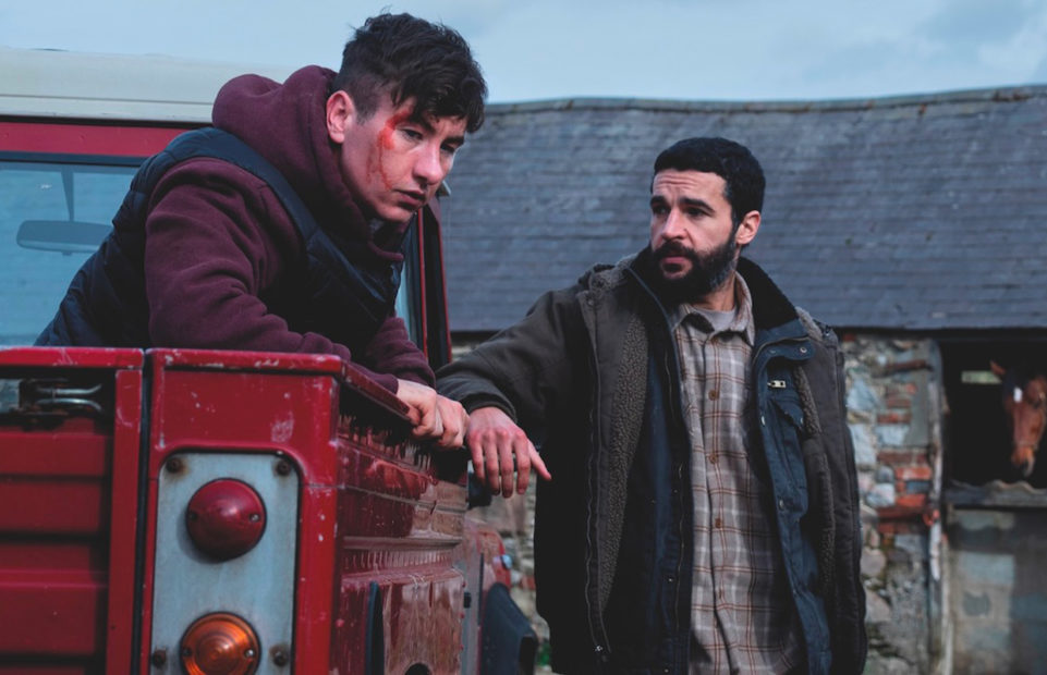 Two men on a farm, one in a pick-up truck.
