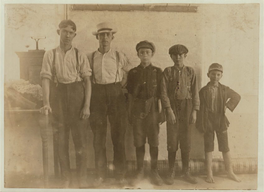 Two teenagers, two young boys and one very young barefoot boy (primary-school age).