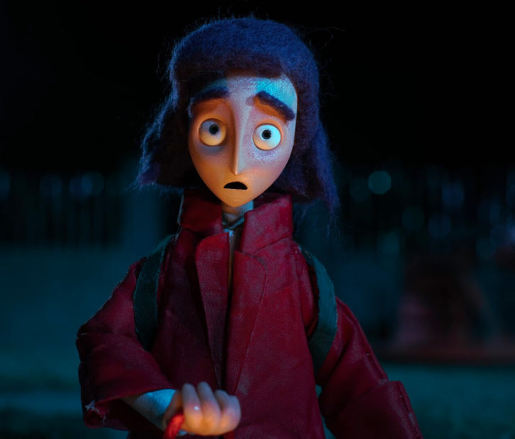 A still from the short film Nobody to Play With showing a young girl outside in the dark, staring at the camera.