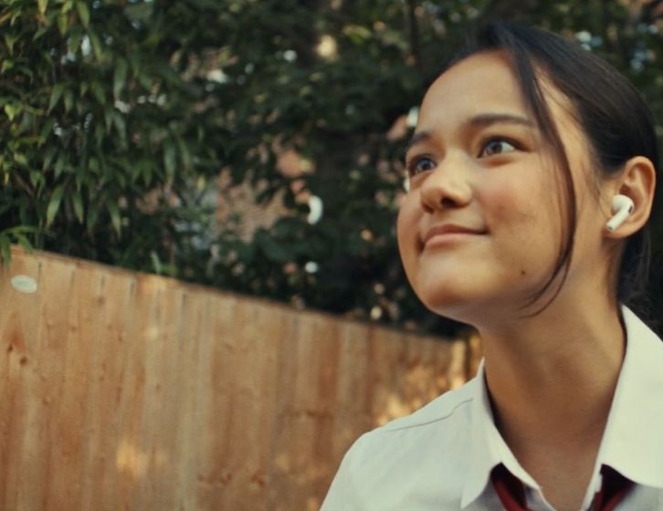 A girl with earpods in.