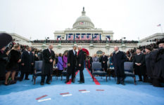 Joe Biden converses with Barack Obama at Obama's second inauguration.