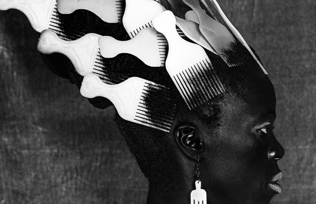 Self-portrait by Zanele Muholi with combs in their hair that look like sails.