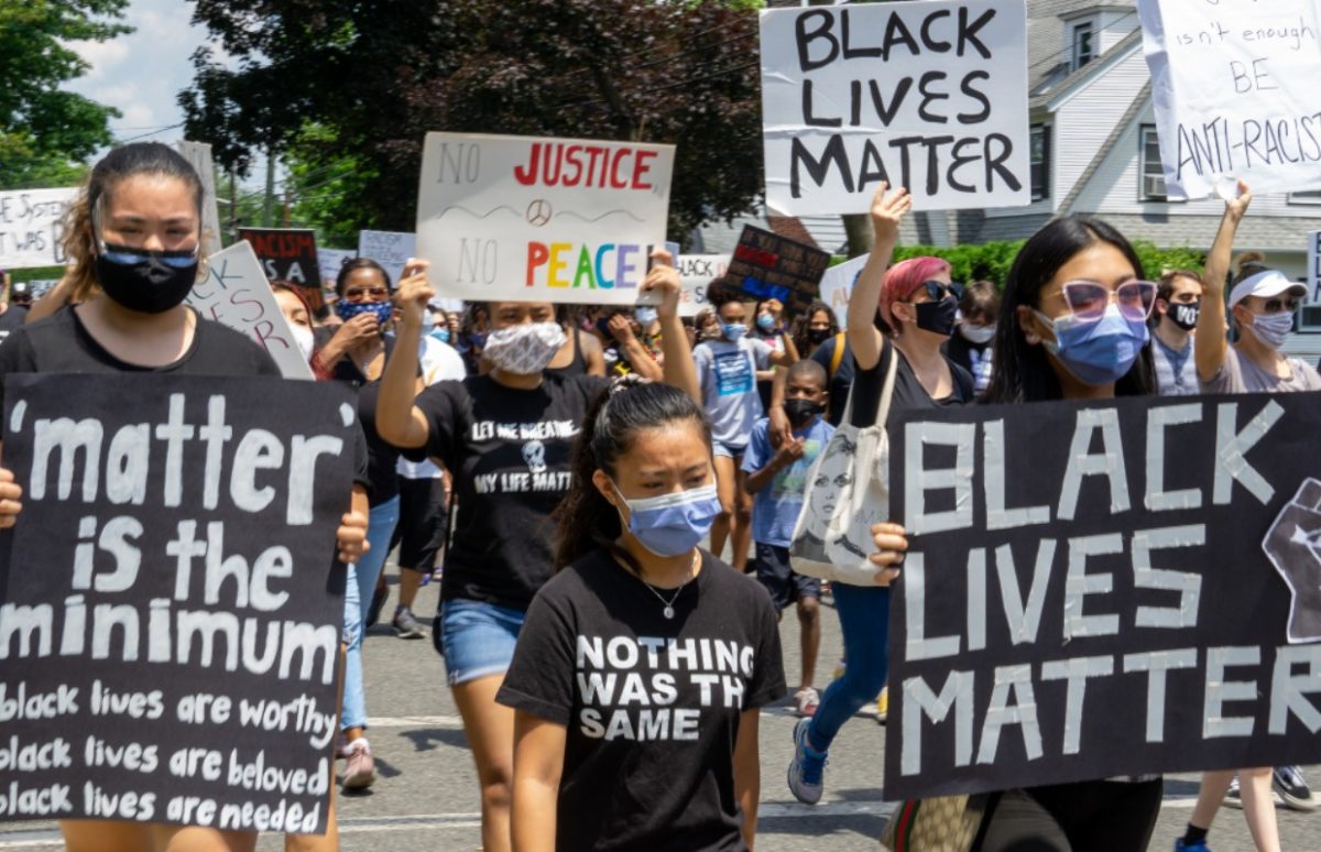Crowd of protesters holding Black Lives Matter signs in the street in Teaneck, New Jersey, 19 June 2020