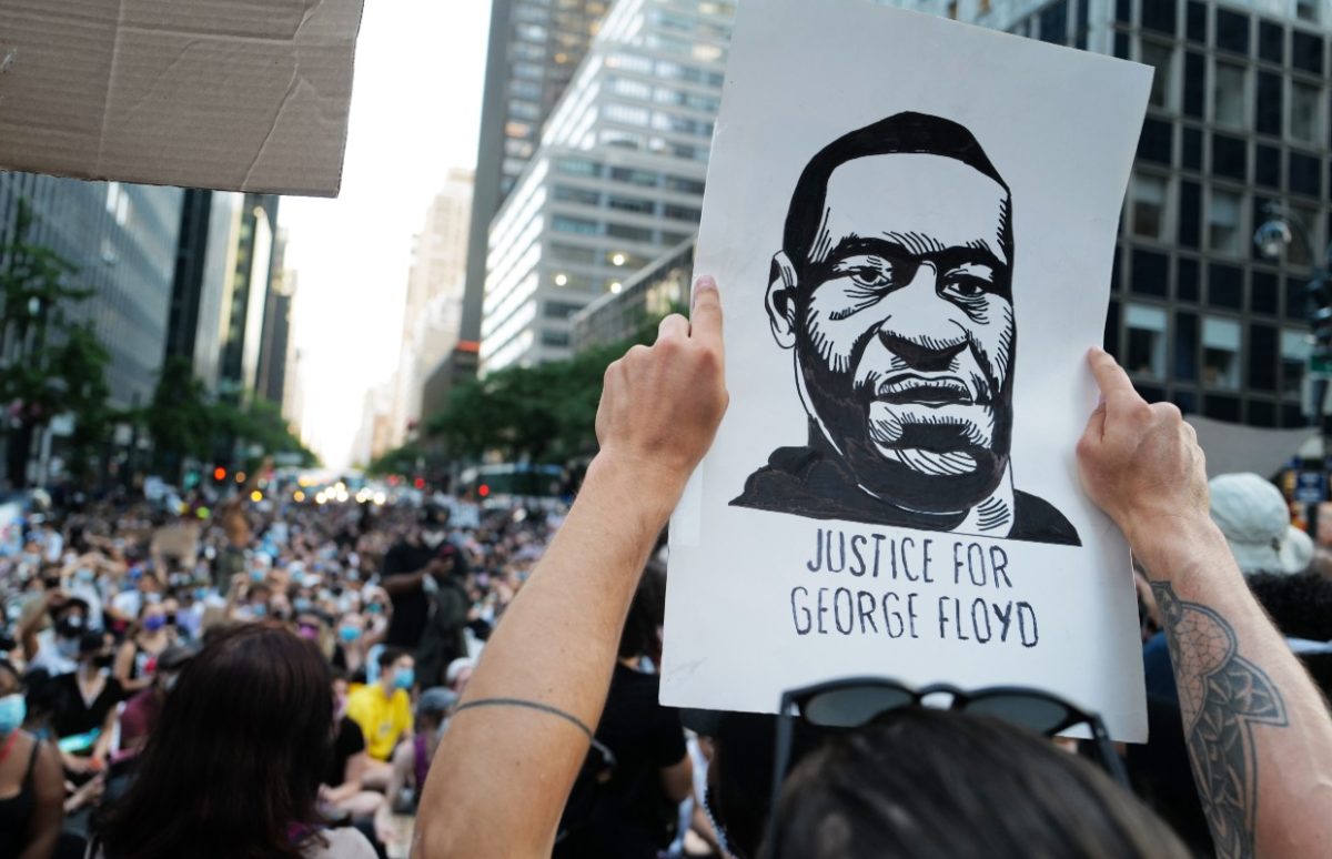 A man holding a placard saying Justice for George Floyd at a Black Lives Matter demonstration in NYC, 10 June 2020