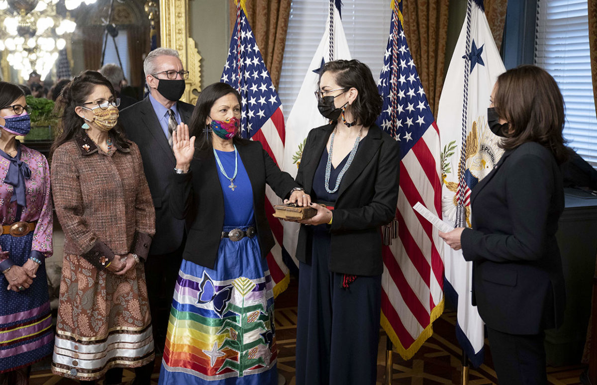 Deb Haaland is sworn in as Interior Secretary by Vice-President Kamala Harris, wearing traditional tribal dress.