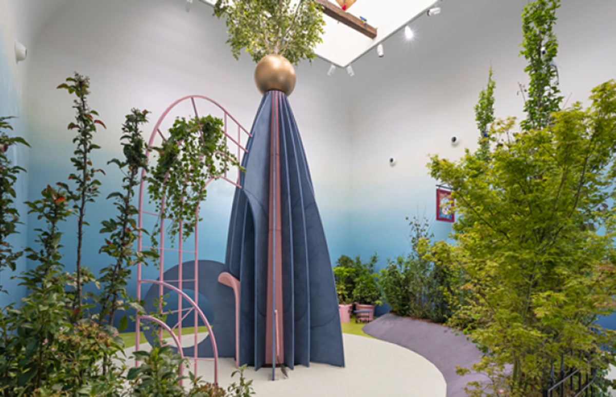 An indoor garden with a blue pyramid-type structure.