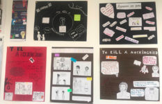 Posters about To Kill a Mockingbird made by students and displayed on a classroom wall.