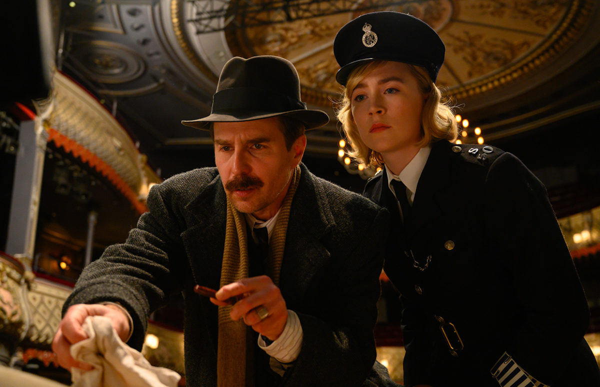 Sam Rockwell and Saoirse Ronan in the film, examining the crime scene in a theatre