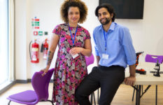 Two teachers in a classroom, facing the camera.