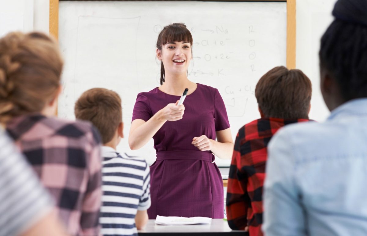 A teacher exchanging questions and responses with her class.