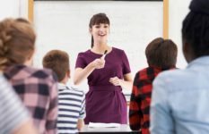 A teacher exchanging questions and responses with her class.