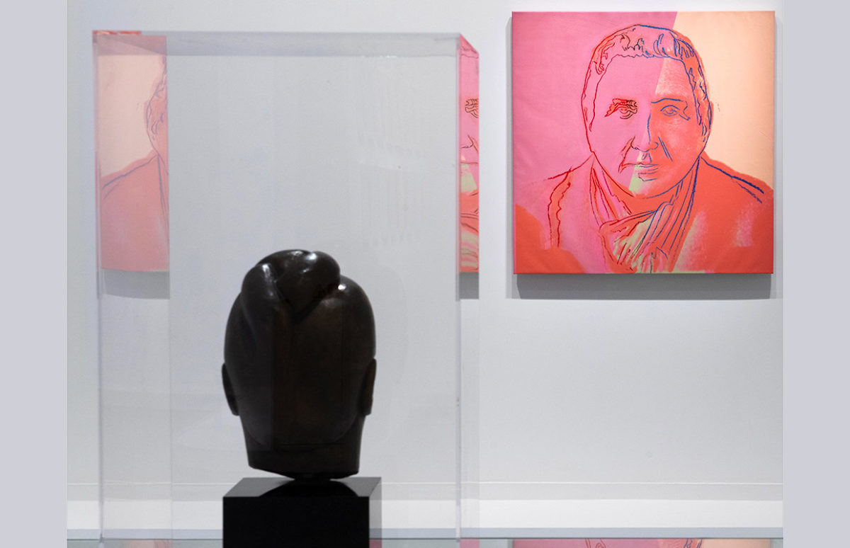 A view of the exhibition with a portrait of Gertrude Stein by Andy Warhol.