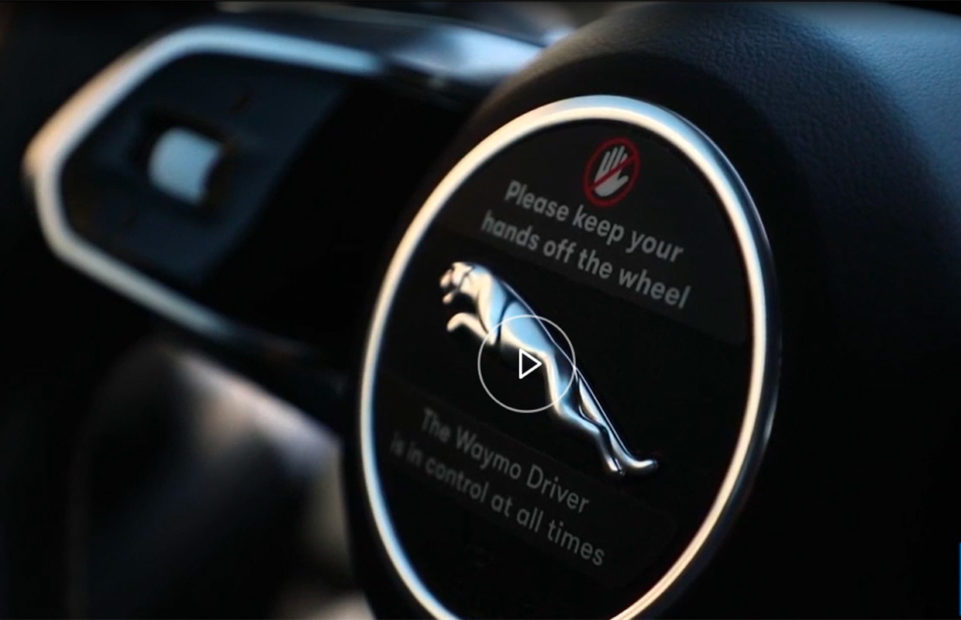 A steering wheel with a message asking passengers not to touch the wheel.