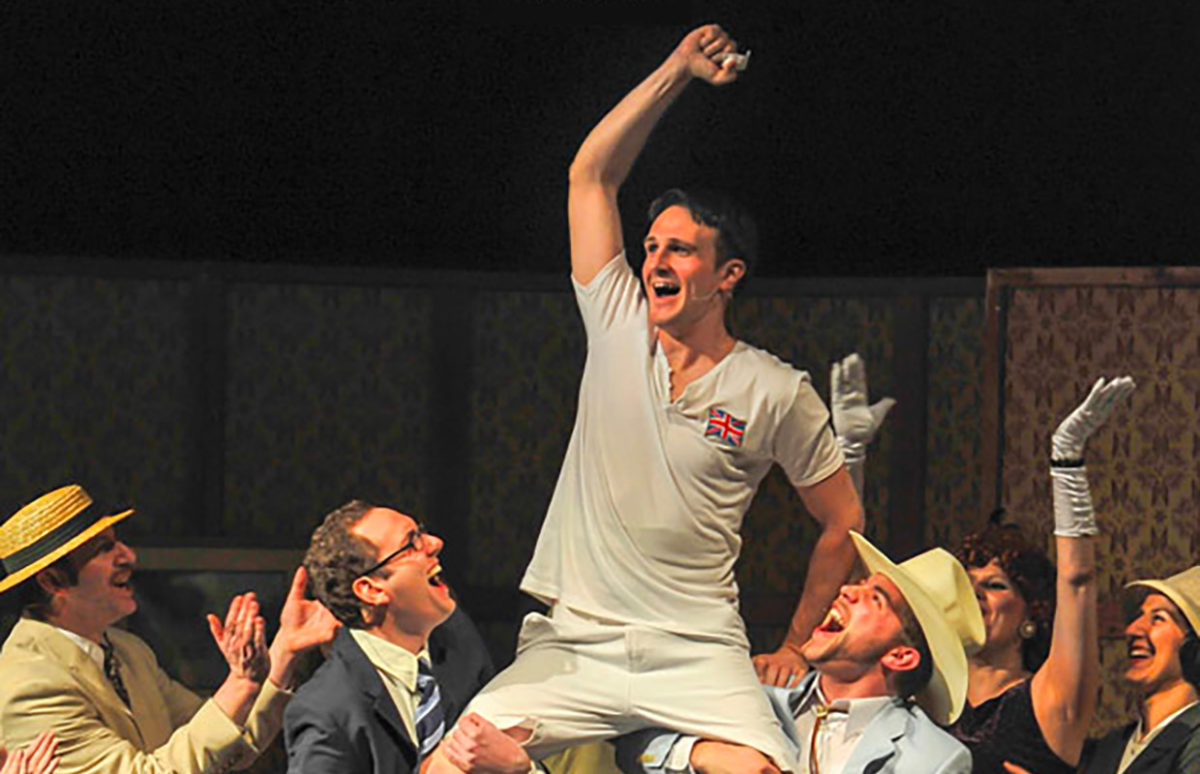 An image of the Eric Liddell character celebrating, carried on other actors' shoulders, from the play Eric Liddell Chariot of Fire.