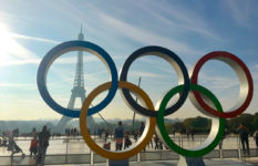 The Olympic rings with the Eiffel Tower in the background.