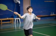 A boy playing badminton.