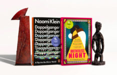 The Women's Book prizes for non-fiction and fiction winning books, Doppelganger by Naomi Klein and Brotherless Night by V. V. Ganeshananthan, along with the statuettes for the two prizes.