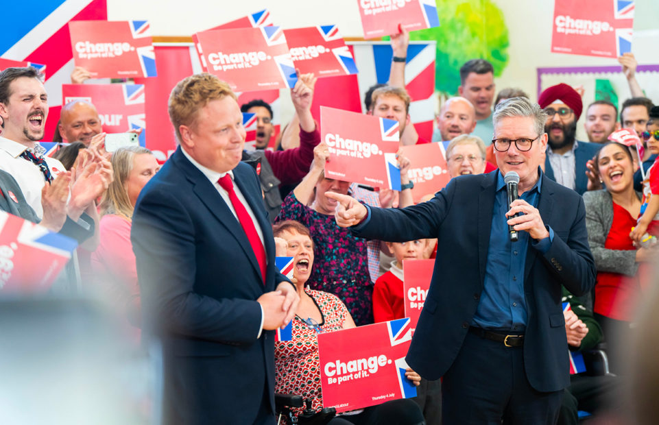 Keir Starmer, right, during the campaign, with Chris Bloore, Labour’s candidate for Redditch, and a croud of people holding signs with the slogan Change.