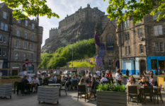 Edinburgh Castle perched on its volcanic rock, seen from below in the Grassmarket, part of the Old Town.