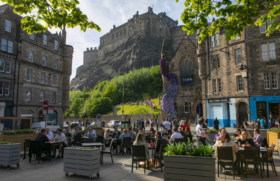 Edinburgh Castle perched on its volcanic rock, seen from below in the Grassmarket, part of the Old Town.