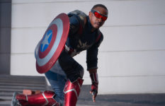 Anthony Mackie as Captain America, crouched down holding his iconic shield.