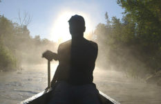 Eddy L. Harris canoeing down the Mississippi.