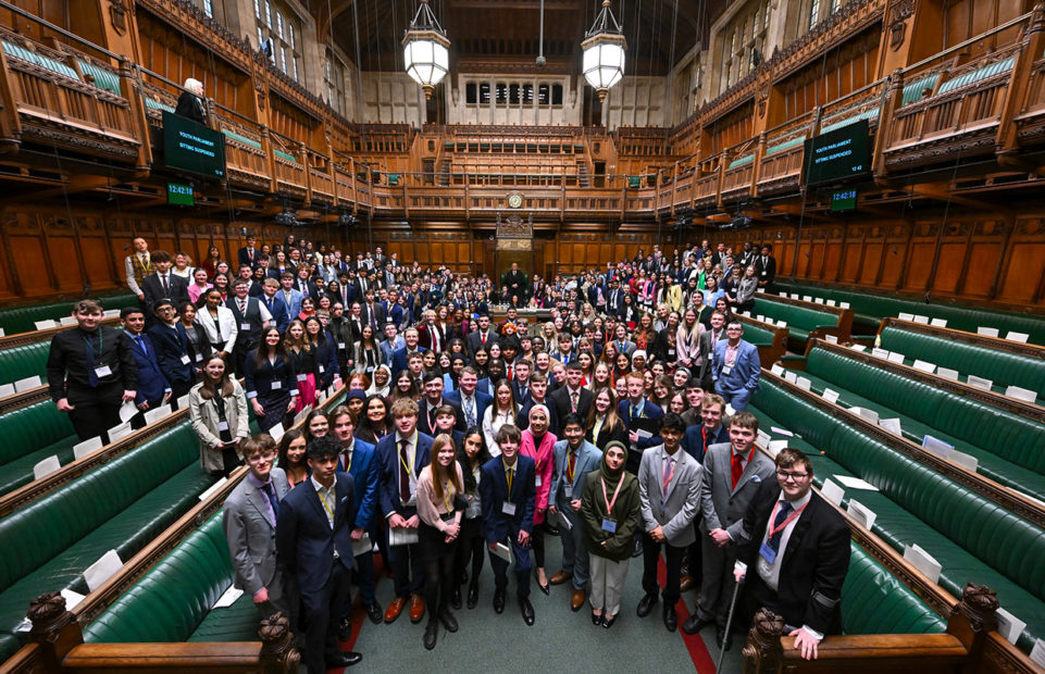 A group photo of the Members of the Youth Parliament in the House of Commons chamber.