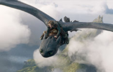 The character Hiccup riding on his dragon.