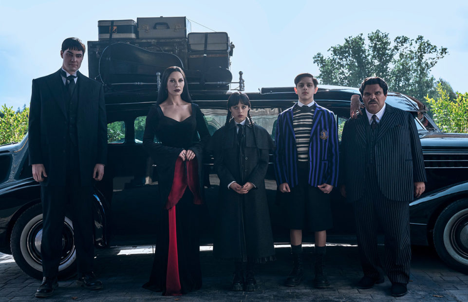 The Addams family and Lurch in front of their luggage-laden car, arriving at Nevermore for the start of term.