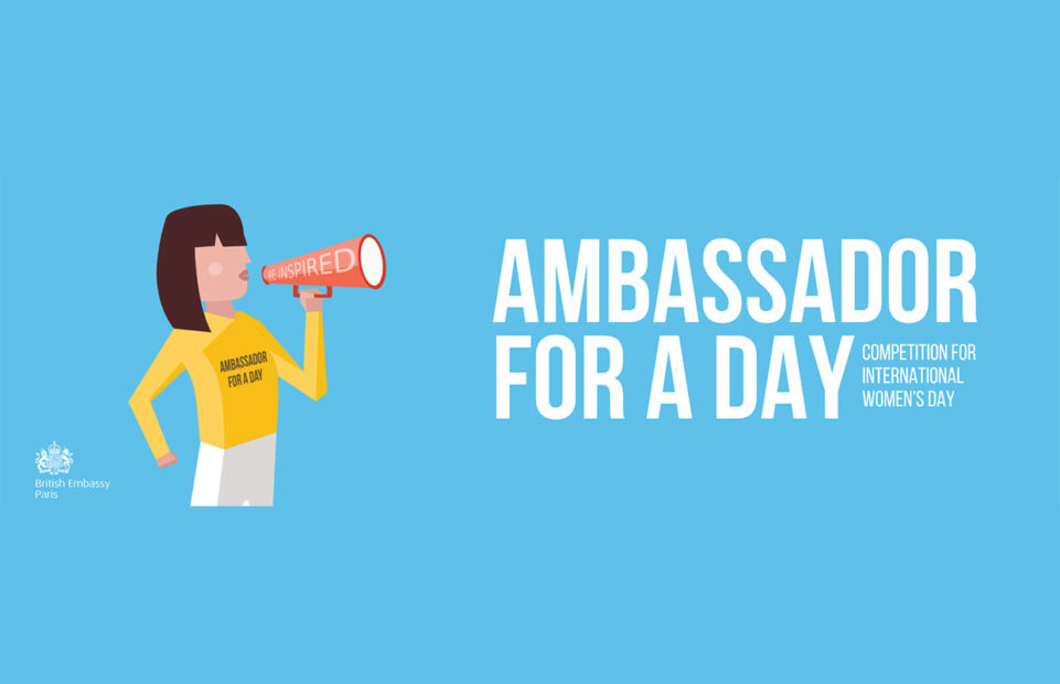 A young woman with a megaphone and banner saying Ambassador for a Day