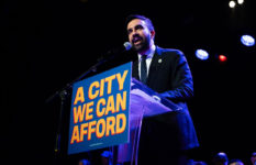 Zohran Mamdani at a lectern that bears the slogan A city we can afford.